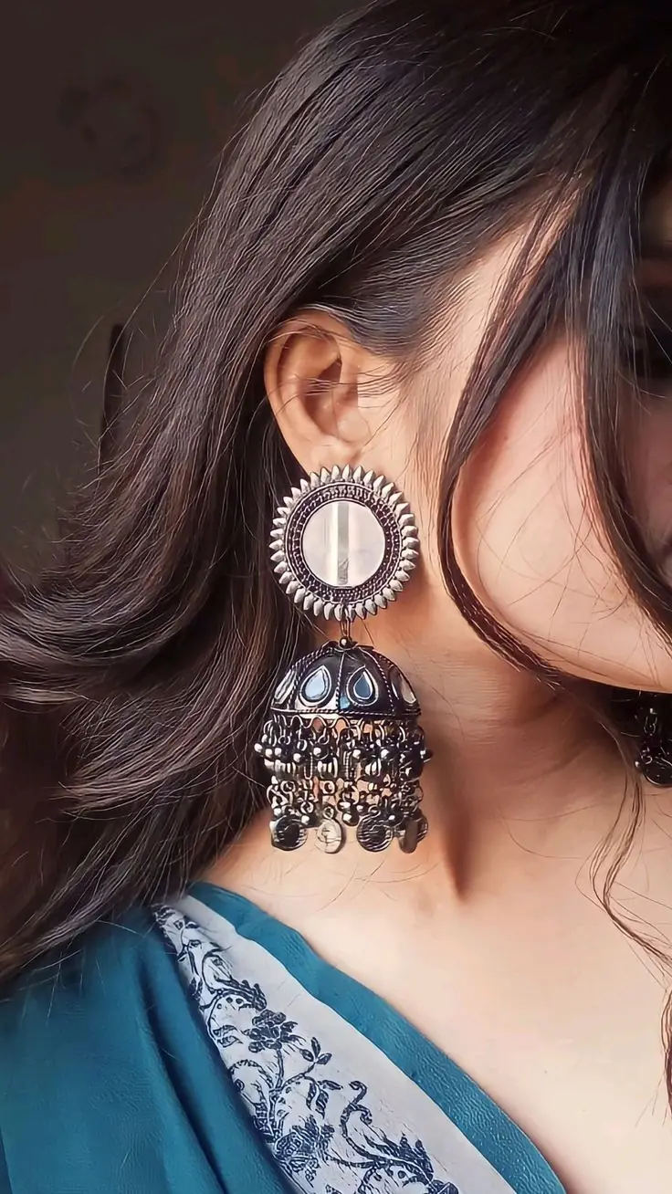Model wearing a large oxidised jhumka