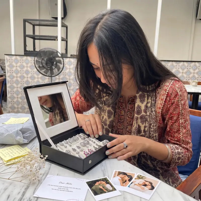 A woman opening a Craftybella mirror jewellery box full of earrings